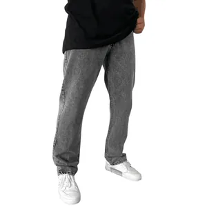 Detailed view of men's straight-leg grey denim jeans paired with casual white sneakers