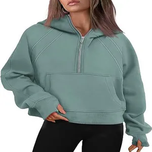 Women's stylish half-zip cropped hoodie in sage green with kangaroo pocket detail