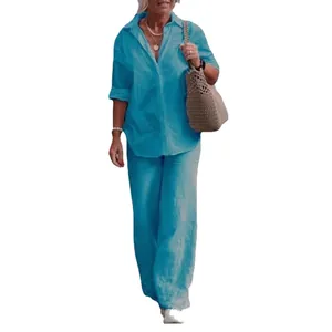 Stylish turquoise linen two-piece set featuring a button-down shirt and matching wide-leg trousers