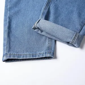 Close-up of classic blue denim jeans showing cuff detail and high-quality stitching
