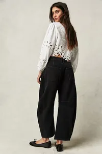 Back view showing the relaxed fit of women's washed black wide-leg denim trousers