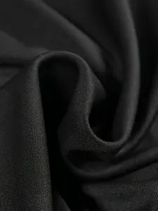Macro detail of the high-quality black fabric texture for women's varsity jackets