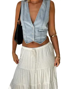 Detail view of stylish light blue v-neck denim vest styled with a white skirt and black bag