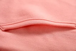 Macro detail of the pocket seam and soft pink fabric texture on a casual hoodie