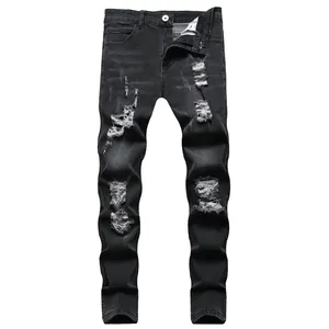 Close-up view of black distressed men's slim fit jeans with ripped details