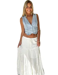 Women's casual light blue denim vest jacket paired with a white tiered bohemian maxi skirt