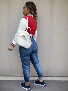 Back view of a red and white color-block varsity jacket for women in streetwear style
