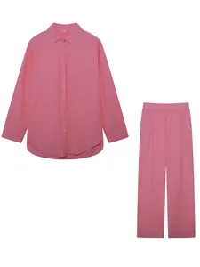 Flat lay detail of a pink two-piece casual set with button-down shirt and trousers