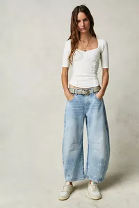 Full view of women's loose wide-leg washed denim jeans in light blue