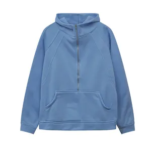 Close-up detail of light blue half-zip cropped hooded sweatshirt with kangaroo pocket