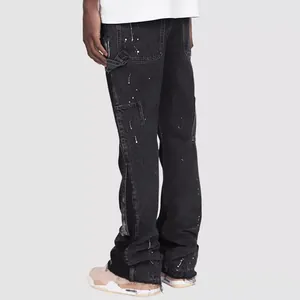 Back view of black paint splatter denim carpenter pants with flared layered hem