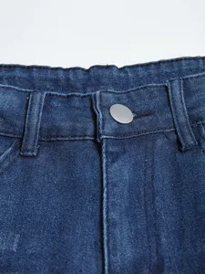 Close-up detail of silver metal button and waist stitching on men's slim blue denim jeans