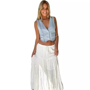 Stylish women's light blue denim vest paired with a elegant long tiered white skirt