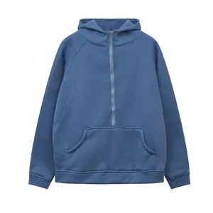 Close-up detail of a blue half-zip hooded sweatshirt featuring a front kangaroo pocket