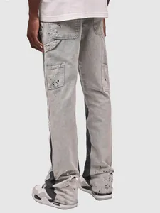 Back view of men's washed gray denim carpenter pants with white paint splatter detail.