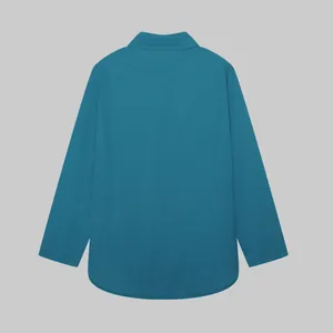 Back view of a casual teal long-sleeved collared shirt for women in solid color