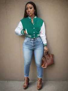 Full-length detail of a green and white color-block varsity jacket for women