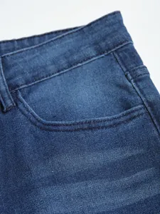 Close-up macro detail of blue denim fabric and pocket on men's slim fit stretch jeans