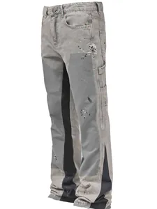Detailed side view of gray men's stacked flare jeans with paint splatters.