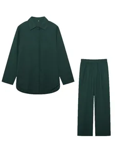 Dark green two-piece loungewear set with long-sleeved shirt and matching wide-leg pants.