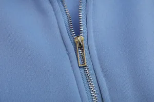 Detailed view of high-quality silver metal zipper on light blue sport fleece hoodie