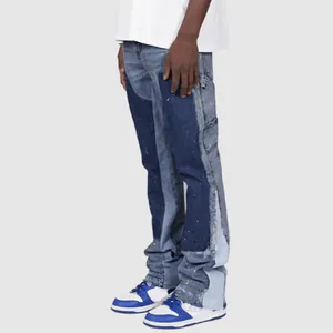 Detailed view of men's blue patchwork stacked flare denim carpenter pants in street style