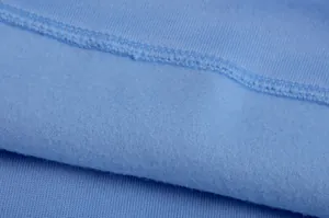 Close-up of light blue soft fleece lining and high-quality stitching on a hoodie