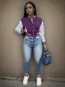 Detail view of a purple and white color-block baseball jacket on a female fashion model