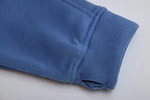 Detailed macro shot of a blue hoodie cuff featuring a functional thumbhole design