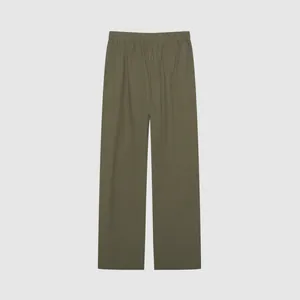 Detail view of army green wide-leg trousers with elastic waistband and relaxed fit