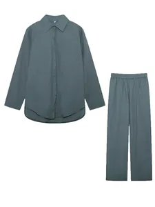 Detailed flat lay of a dusty blue-green two-piece shirt and wide-leg trousers set