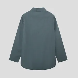 Back view of a solid dark teal long sleeve lapel shirt for women with curved hem.