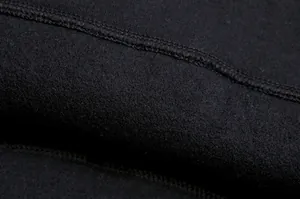 Macro detail of soft black fleece lining and durable stitching on casual hoodie