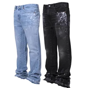 Detail of men's straight-leg jeans with paint splatter effect and distressed hems