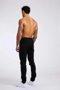 Vue arrière détaillée d'un jean skinny noir pour homme avec une coupe haute ajustée