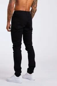 Vue arrière d'un jean en denim noir taille haute pour homme avec une coupe ajustée slim