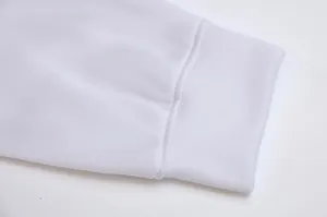 Close-up of white hoodie ribbed sleeve cuff showing quality stitching and soft fabric texture.