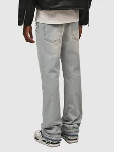 Back view of light blue straight-leg jeans with pearl side embellishments and frayed hem