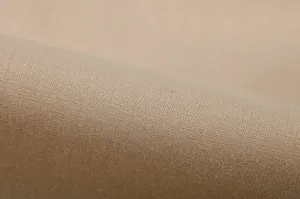 Close-up detail of beige breathable linen fabric texture for women's casual two-piece suit set.