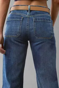 Detailed back view of women's mid-wash blue flare denim jeans with patch pockets