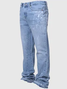 Side view of men's light blue straight-leg jeans featuring a distressed splatter and raw hem.