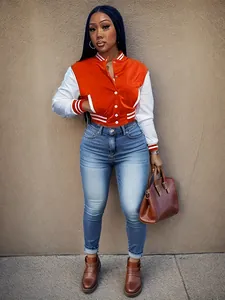 Women's orange and white color-block varsity jacket with snap buttons and striped trim