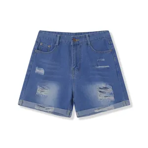 Detail of women's high-waisted blue denim shorts with ripped holes and cuffs