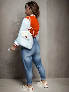 Back view of a vibrant orange and white contrast color varsity jacket for women