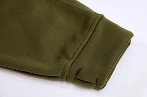 Close-up of olive green hoodie cuff with rib-knit texture and functional thumbhole detail