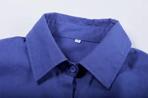 Detailed macro shot of the blue long-sleeved shirt collar featuring a white size S label