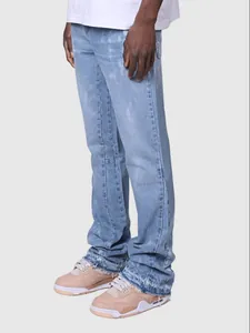 Men's light blue straight-leg denim jeans with frayed hems and street fashion style.