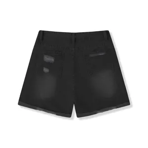 Detailed back view of women's black distressed denim shorts with ripped pockets and raw hems