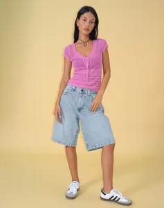 Full body model view of women's retro loose light blue denim shorts in casual styling