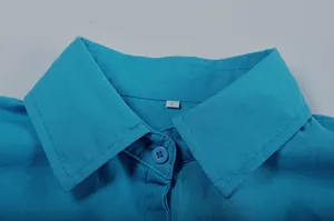 Macro detail of blue button-down shirt collar with fabric texture and size S tag